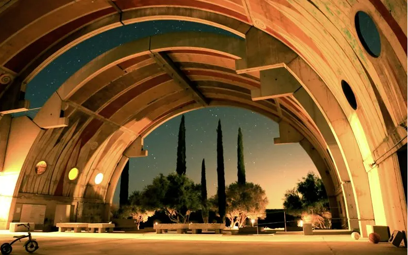 Concrete vault architecture at Arcosanti in the Arizona desert with clear sky