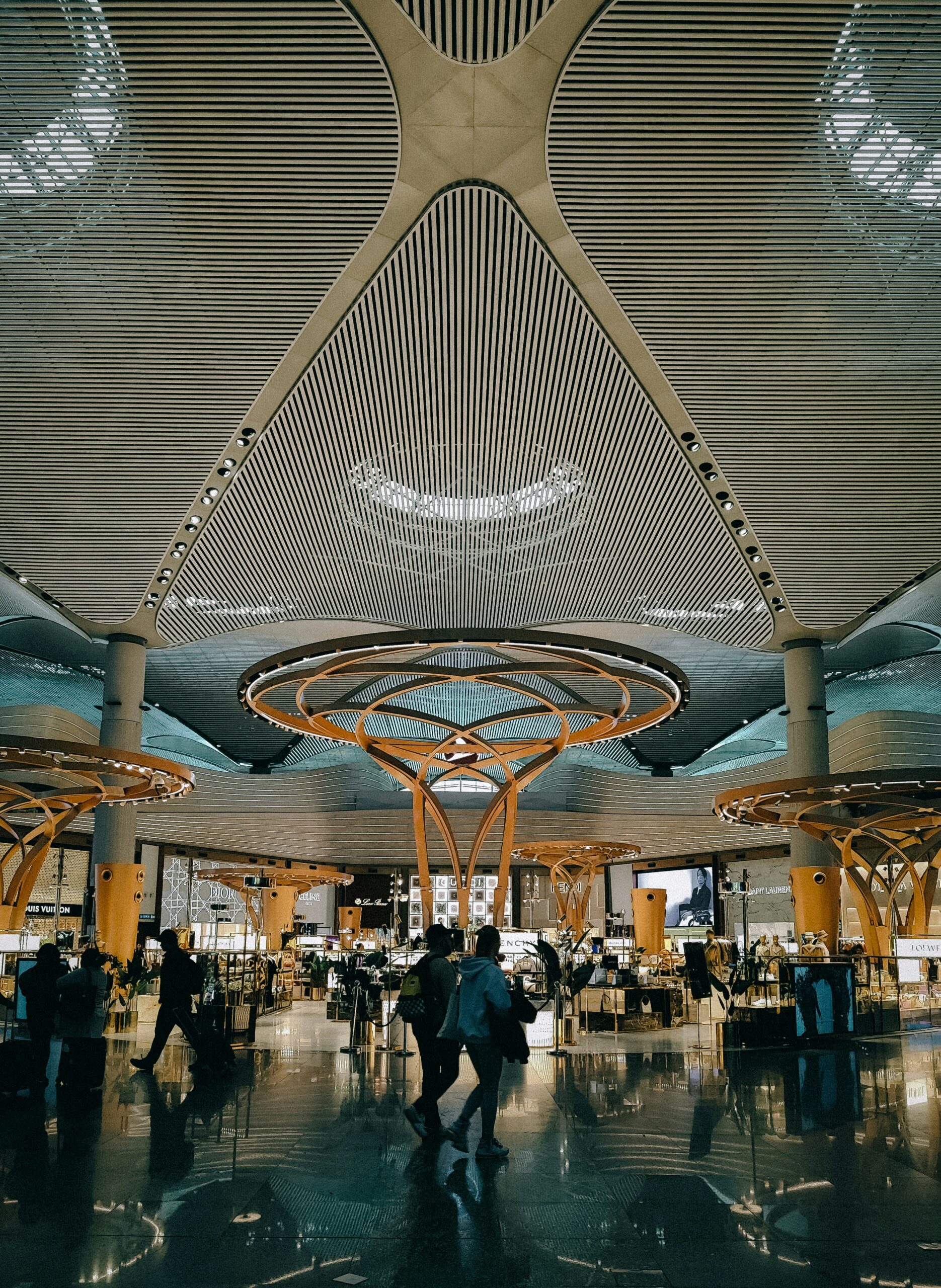 European airport arrivals hall with warm natural light and modern architecture