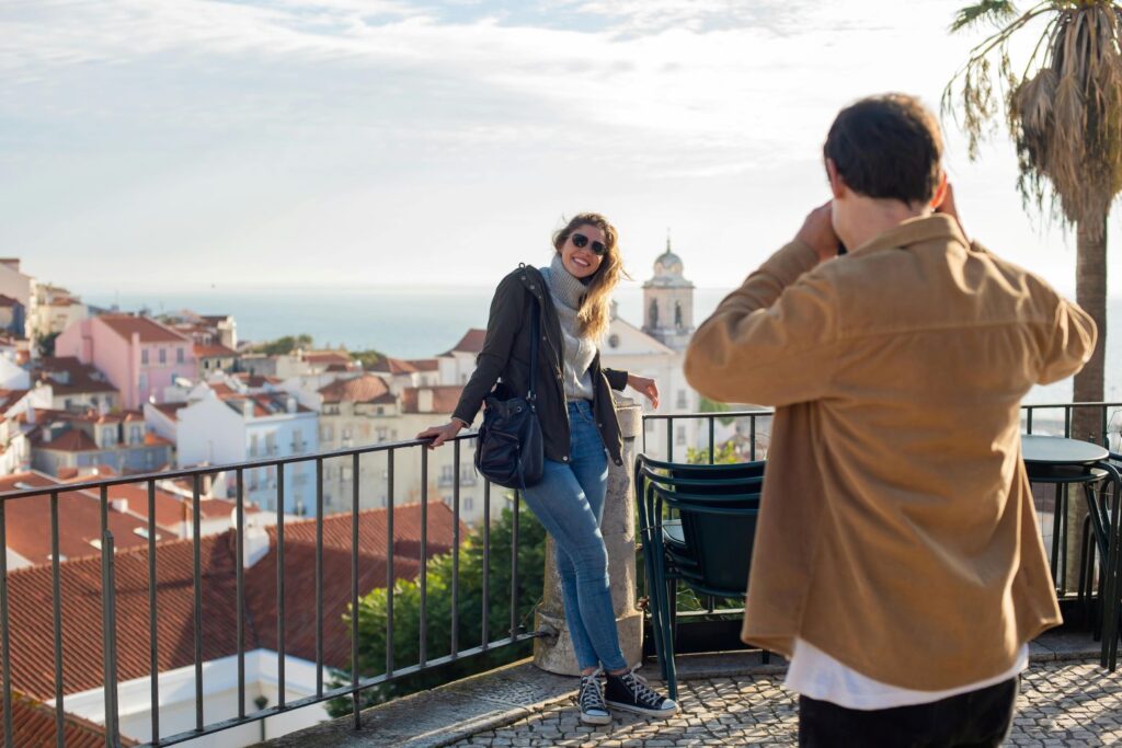 Couple exploring a charming European street lined with cafés and boutiques