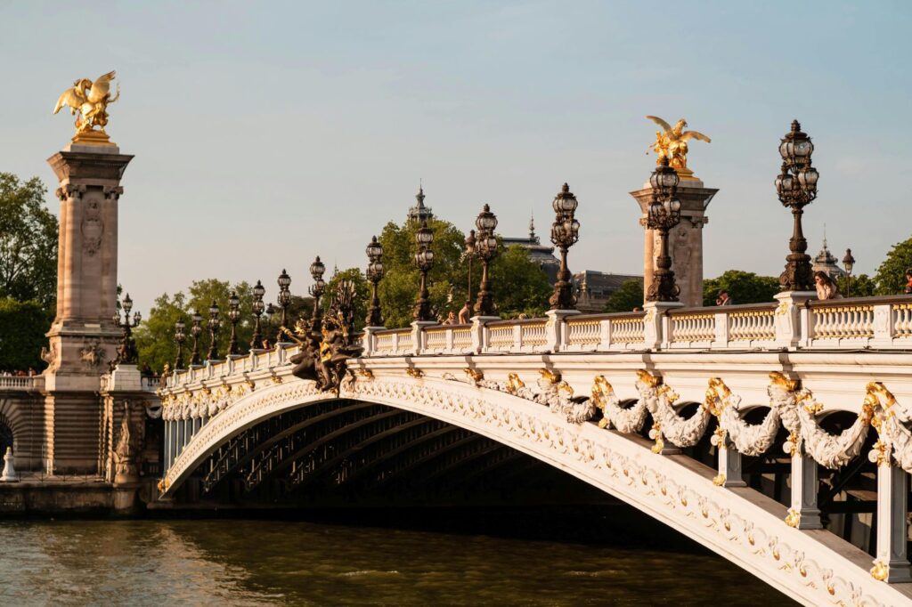 Iconic Parisian bridge connecting the riverbanks, surrounded by charming architecture