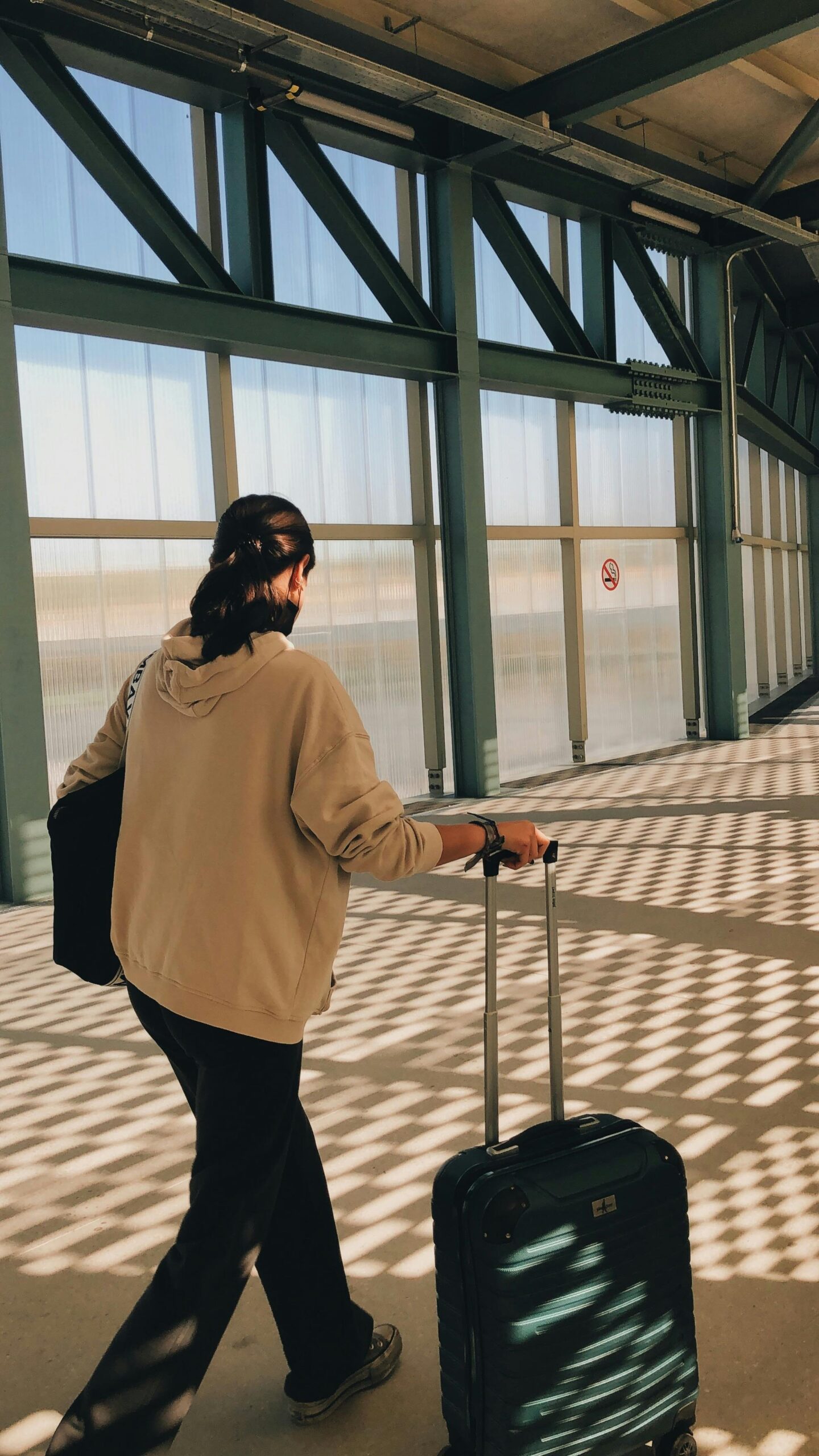 Traveler at the Airport Wheeling Luggage to the Departure Gate